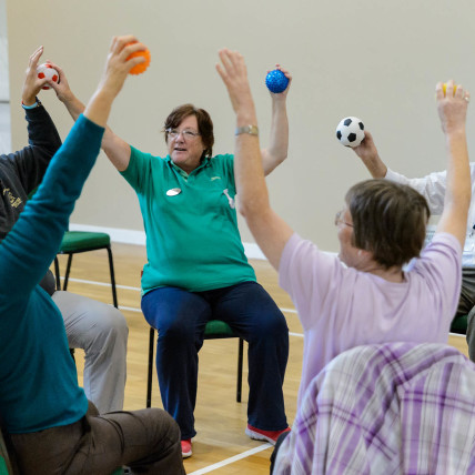 Older people in a seated exercise class