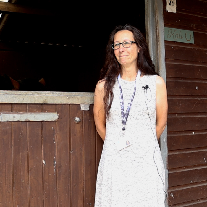 Linda, a Care Coordinator in Salisbury, stood next to a horses stable. 
